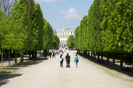 VIENNA, AUSTRIA - APR 30th, 2017: Public park in Schonbrunn Palace Schonbrunn Palace. Its a former imperial 1441-room Rococo summer residence of Sissi Empress Elisabeth of Austria in modern Wien. Tourist walking in the parkのeditorial素材