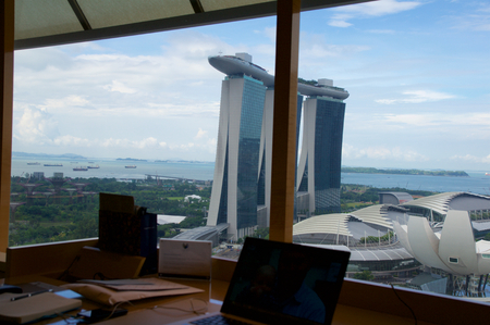 SINGAPORE - JULY 23rd, 2016: luxury Hotel room with modern interior and an awesome view of the Marina Bay, working desk laptopのeditorial素材