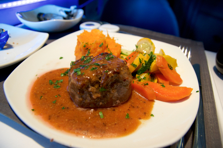 TORONTO, CANADA - JAN 21st, 2017: Air Canada Business Class in-flight meal, Beef fillet, mustard sauce, mashed potatoes as an main courseのeditorial素材