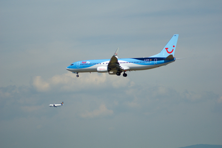 FRANKFURT, GERMANY - JUL 09th, 2017: TUIfly AIRLINES Boeing 737-800 lands at Frankfurt airport with other plane in the background, Boeing 737 Next Gen, MSN 41660, Registration D-ATUN, TUIfly-a German leisure airline owned by the travel and tourism companyのeditorial素材