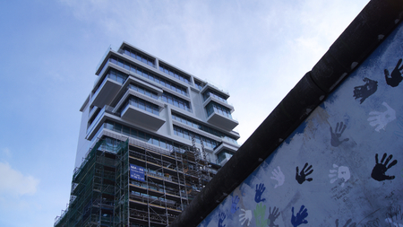 BERLIN, GERMANY - JAN 17th, 2015:The Berlin Wall and new high rise Apartment building at East side...