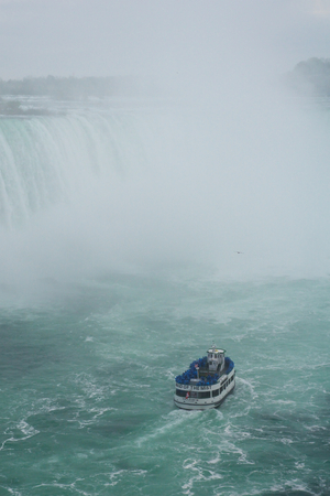 NIAGARA FALLS, ONTARIO, CANADA - MAY 20th 2018: Touristic boat on Horseshoe Falls, also known as Canadian Fallsのeditorial素材