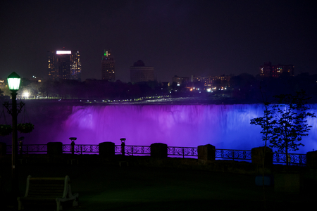 NIAGARA FALLS, ONTARIO, CANADA - MAY 21st 2018: Niagara Falls illuminates the falls at night on the Canadian and American sidesのeditorial素材
