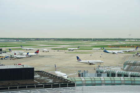CHICAGO, ILLINOIS, UNITED STATES - MAY 11th, 2018: Several Airlines jet parking on gate position at Chicago OHare International Airport in the morningのeditorial素材