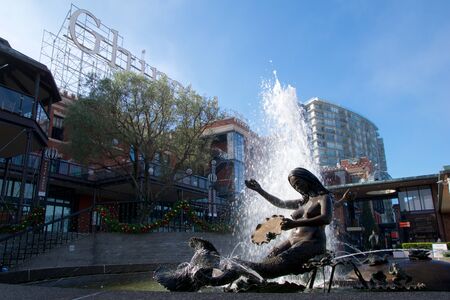SAN FRANCISCO, CALIFORNIA, UNITED STATES - NOV 25th, 2018: Visitors in Ghirardelli Square with fountain.Its a famous landmark public square with shops and restaurants of San Franciscoのeditorial素材