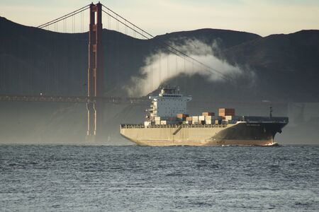 SAN FRANCISCO, CALIFORNIA, UNITED STATES - NOV 25th, 2018: A fast moving cargo container ship,...