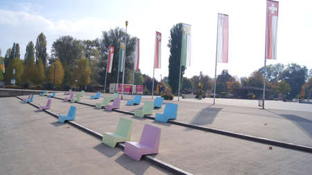 KREUZLINGEN, SWITZERLAND - 14 OCT 2015: Kreuzlingen harbour promenade with colourful seats and a view of Lake Constanceのeditorial素材