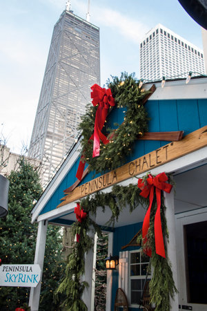 CHICAGO, ILLINOIS, UNITED STATES - DEC 11, 2015: Wooden hut decorated for Christmas at a Christmas market in Chicago with the John Hancock Center in the backgroundのeditorial素材
