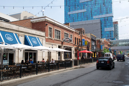 DETROIT, MICHIGAN, UNITED STATES - May 22, 2018: Street in the Greektown district of Detroit with restaurants in historic buildings and a skyscraper in the backgroundのeditorial素材
