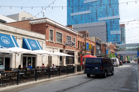DETROIT, MICHIGAN, UNITED STATES - May 22, 2018: Street in the Greektown district of Detroit with restaurants in historic buildings and a skyscraper in the background.のeditorial素材