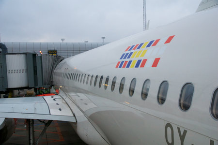COPENHAGEN, DENMARK - NOV 24, 2018: Airbus A320 with SAS Scandinavian Airlines at the gate with a view over the wing during boarding via the rear doorのeditorial素材