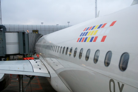 COPENHAGEN, DENMARK - NOV 24, 2018: Airbus A320 with SAS Scandinavian Airlines at the gate with a view over the wing during boarding via the rear doorのeditorial素材