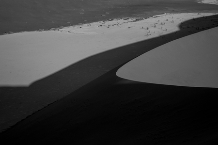 Climbing Big Daddy Dune during Sunrise, Looking onto Sossusvlei Salt Pan, Desert Landscape, Namibiaの写真素材