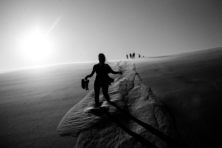 People Climbing Down Big Daddy Dune into Sossusvlei Salt Pan, Desert Landscape, Namibiaの写真素材