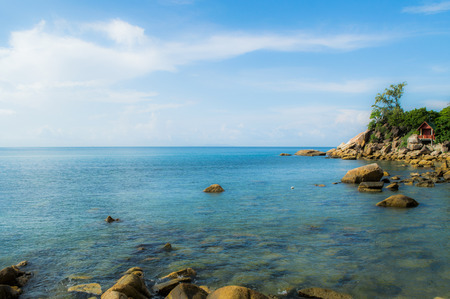 Beautiful Bay and Beach with Rocks, Palms and a Hut on Koh Pha Ngan, Thailandの写真素材