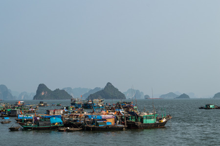 Limestone Formations and Boats in the Ocean at Ha Long Bay, Vietnamの写真素材