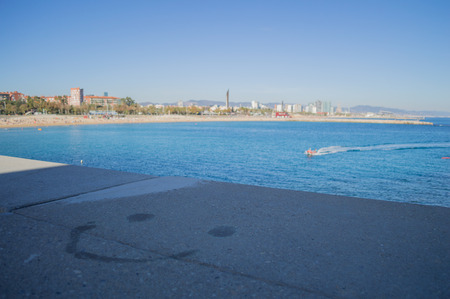 Smiley Face on Ledge with Sea View, Barcelona, Spainの写真素材