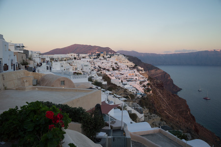 Whitewashed Houses on Cliffs with Sea View and Sunset in Oia, Santorini, Cyclades, Greeceの写真素材