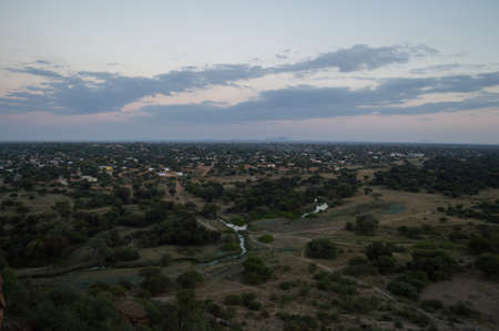 Sunset with Landscape and Cityscape seen from a Hill in Mochudi, Botswana, Africaの写真素材