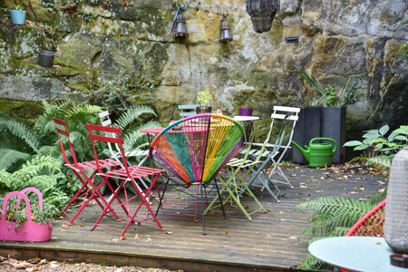 Patio with wooden deck and colorful chairs in Luxembourgの写真素材