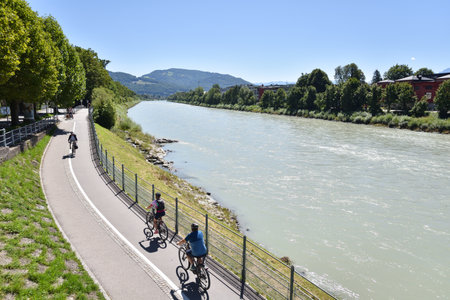 Cyclists Along Salzach River with Landscape in Salzburg, Austriaの写真素材