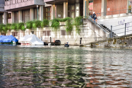 A Diver Collecting Trash from a Canal in Zurich, Switzerlandの写真素材