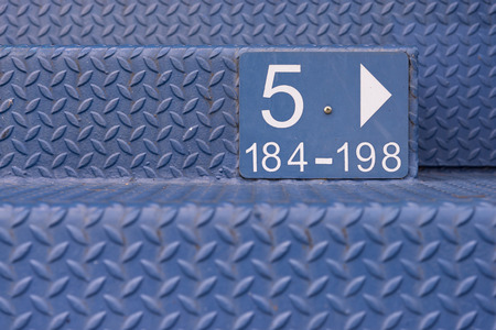 Staircase made with grey steel diamond plate with row mumber of the chair in a studiumの写真素材