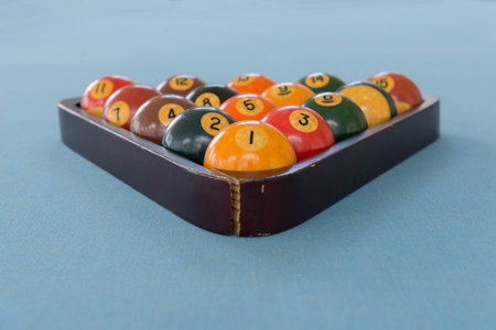 pool billiards snooker balls on green table with locked in wooden cageの写真素材