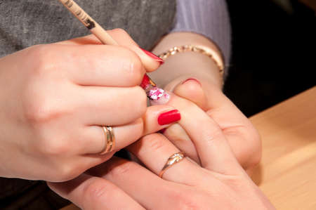 Manicure. Drawing a picture on a nail.の写真素材