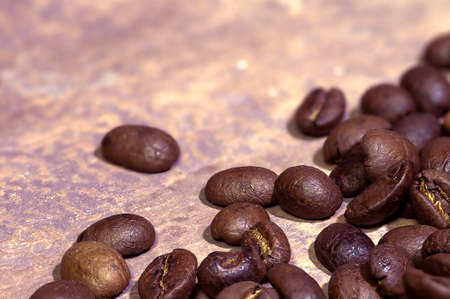 Dark roasted coffee beans in brown tones. Macro. Selective focus.