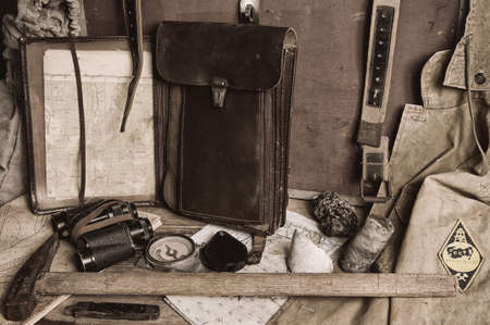 Geological fieldwork tools: map case, geological hammer, compass, magnifying glass, pocket knife, binoculars, storm jacket, drill core, rock samples, topographic and geological mapsの写真素材