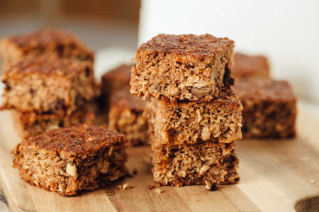 A close up of four slices of apple and walnut bread. Arranged on the wooden board. Close up side viewの写真素材