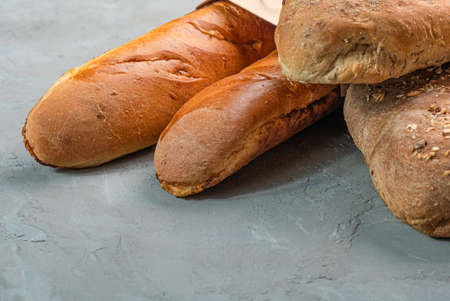 Fresh homemade crisp bread and baguettes close-up. Concept for banners, top view on a gray...