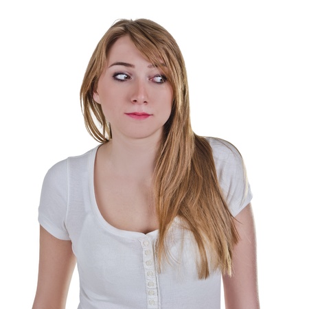 Young woman looking down-left with expression as she is afraid of somethingの写真素材