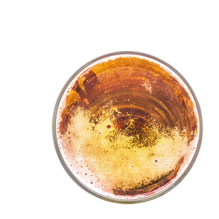 Fresh gold cold and delicious lager beer in glass over white background, shot from aboveの写真素材