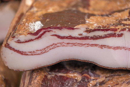 Closeup detail of cut smoked bacon, shallow focusの写真素材