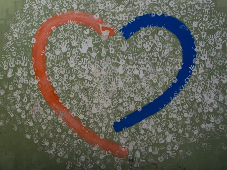 White handprints on a green wall created by people of Hervás as a symbol of solidarity and neighborlyの写真素材