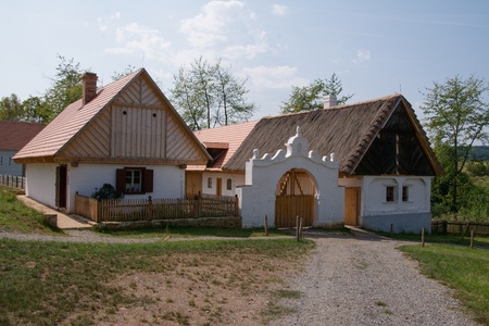 Rural homestead with saddle roof,  farmyard and original decorative gate from the 19th century. Open Air Museum in Kourim, Czech Republicのeditorial素材
