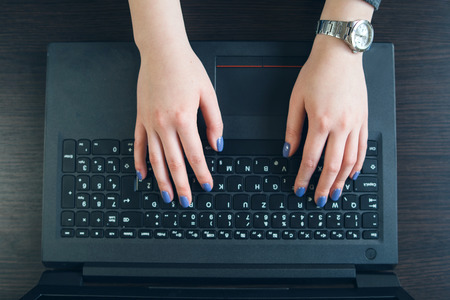 High Angle view on Woman's Hands Typing on the Laptop Keyboardの写真素材