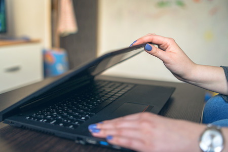 Close up on Female Hands opening the Laptop at Homeの写真素材