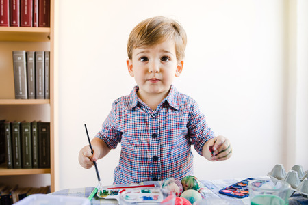 Little Boy using Water Colors To Paint At Homeの写真素材