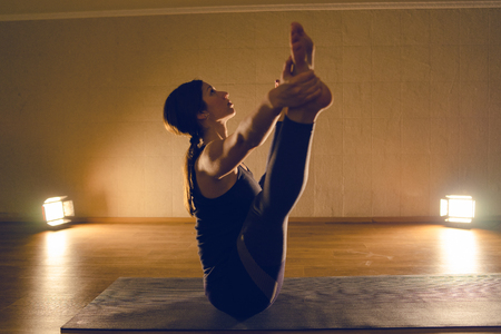 Young Woman in black Practice Yoga At Homeの写真素材