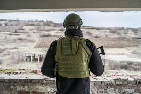 Special forces army soldier military police swat armed with assault rifle on the watchの写真素材