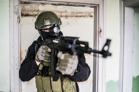 Anti terrorist SWAT special police in action aiming automatic rifle on the rescue mission