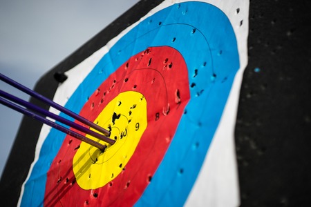 Close up on three arrows in the middle center of the target goal achieved success archeryの写真素材