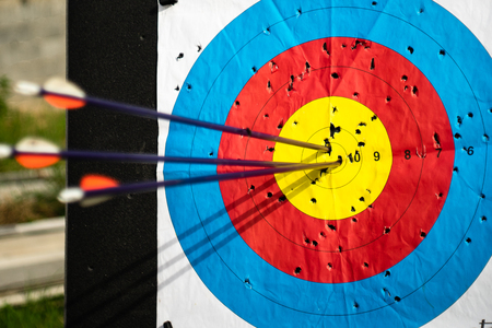 Close up on three arrows in the middle center of the target goal achieved success archeryの写真素材