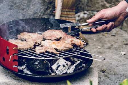 Close up on pork pig meat cooking on the barbeque outdoor grill foodの写真素材