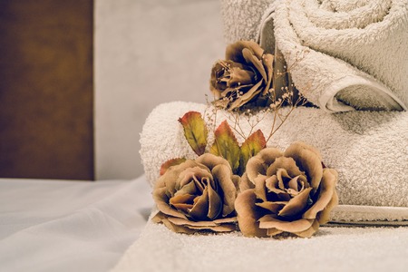 Close up on dy flowers and towels on the massage table at spaの写真素材