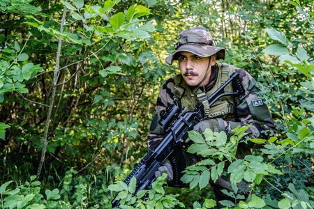 Army soldiers special forces in the wood forest aiming machine gun airsoft game war battle mission campaignの写真素材