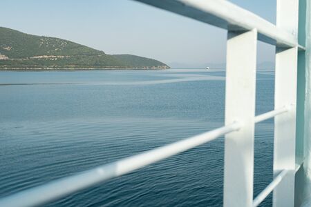Seaside from a deck of the ferry boat ship vessel travel to from the port to the Corfu town in the greece on summer dayの写真素材
